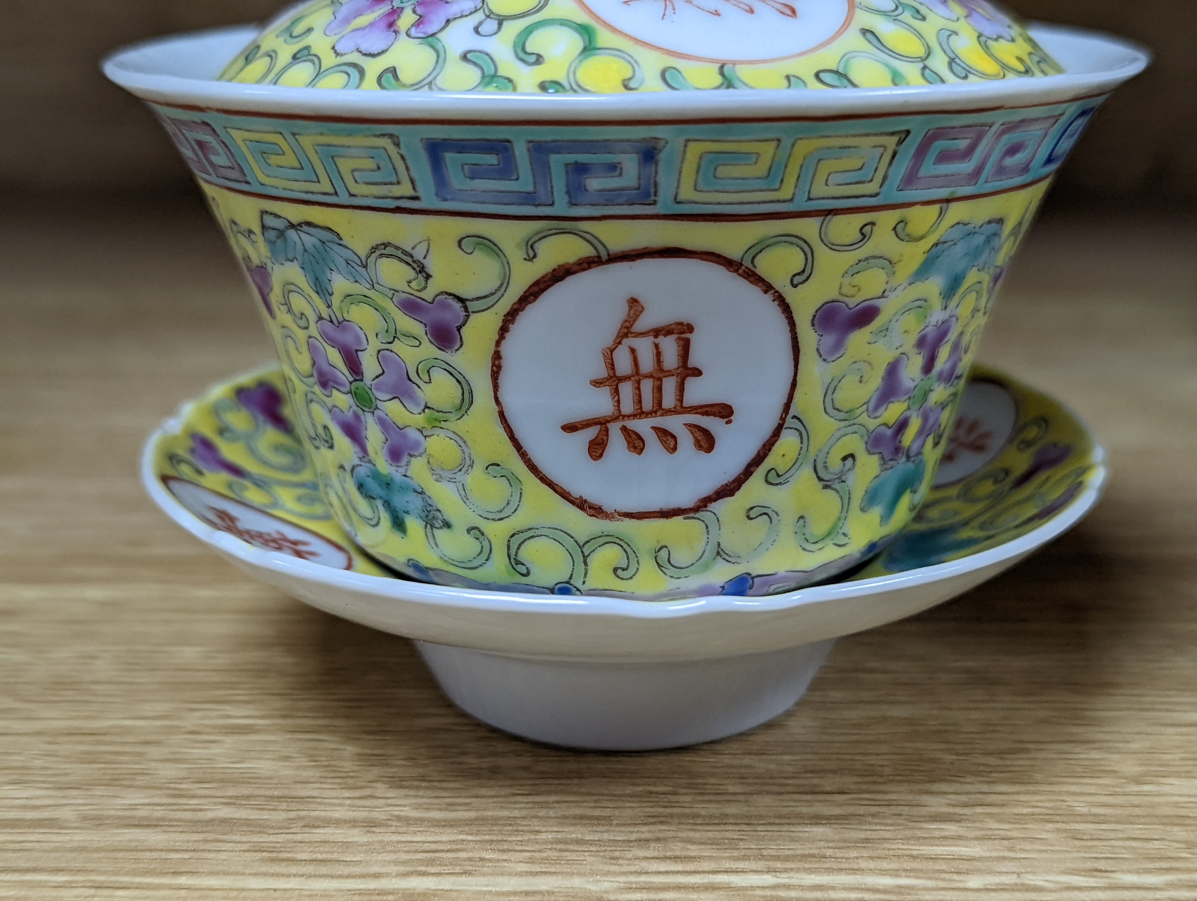 A pair of Chinese enamelled porcelain rice bowls, covers and stands and an odd bowl